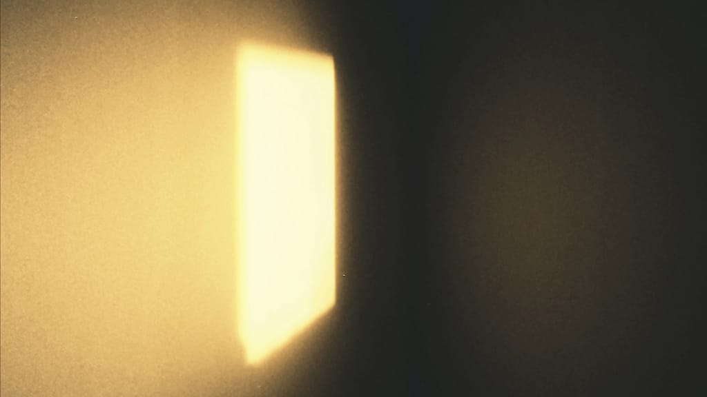 A square of warm dusty light shining on a wall